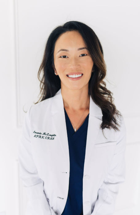 Amanda McLaughlin, APRN, CRNA, founder of Ageless Beauty Bar, in her white coat